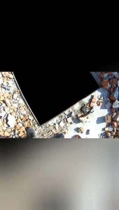 guys throwing rock from roof in abandoned factory building.