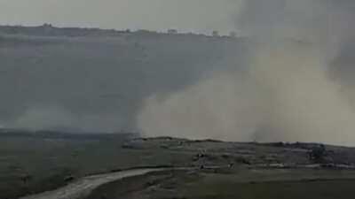 Armenian Su-25 attack aircraft conducting an airstrike on Azerbaijani targets while flying low and popping flares to counter air defenses.