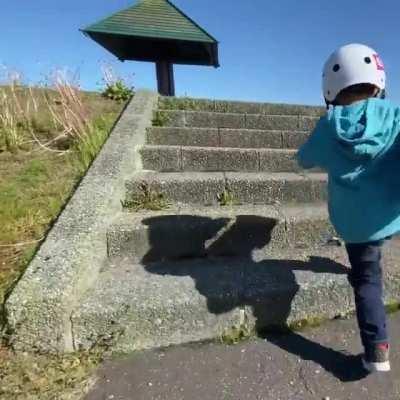 3 year old skater learning to skate down the stairs