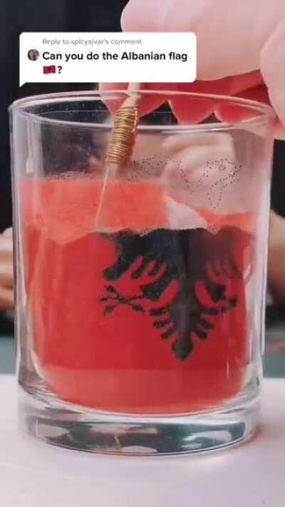 Albanian flag in sand