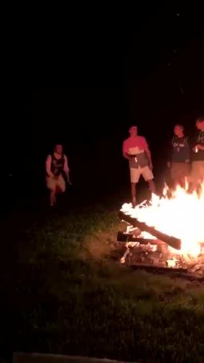 Man jumps too short and lands in the campfire