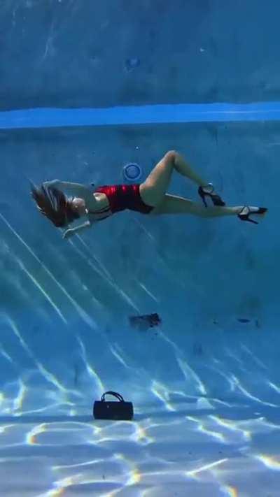 This lady in heels is walking underwater 