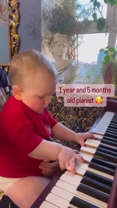 1 year and 5 month old child playing the piano