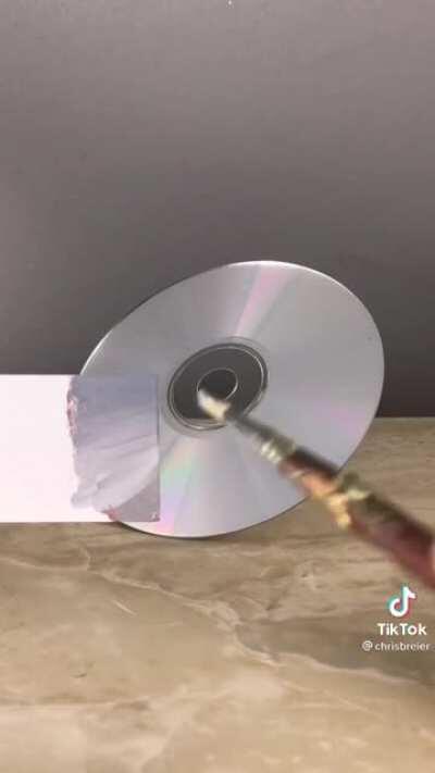 Guy matches the color of a CD with only paint