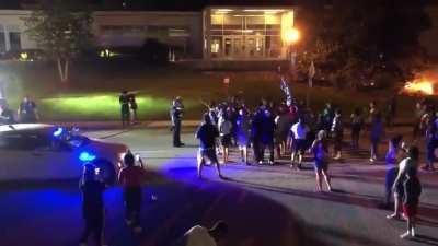 After arsonists start multiple fires in South Caroline last night a single lone police officer tries to offer protection for firefighters to put them out. Protesters throw a rock at him