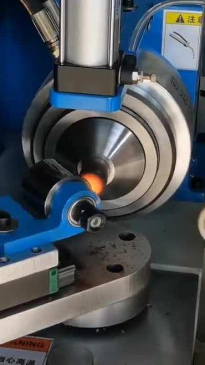 A machine for sealing (and rounding off) pipe ends using heat induction coils.