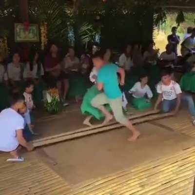 Filipino dancers performing a traditional dance called &quot;Tinikling&quot;