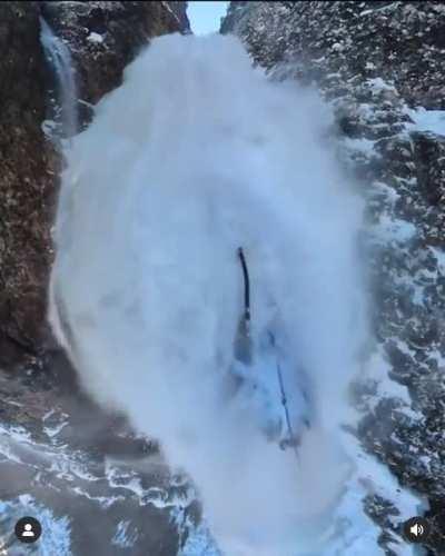 This dude holding onto the side of a mountain as an avalanche consumes him