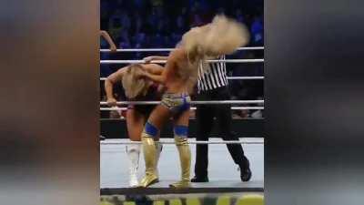 Summer Rae performing a rope Hung knee strikes on Natalya, a movement more typical of Paige