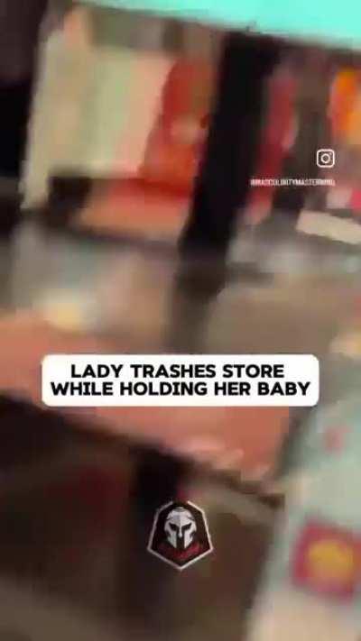 Woman trashes store while holding her baby