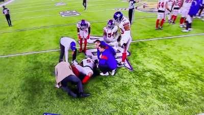 Football trainer tries to make injured player feel better