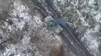 UA drone dropping a grenade on active Russian tank (flag on the barrel is Russian tri-color, and front has a 