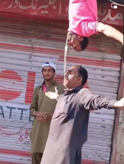 Two men with knives in their mouths, balance them on the tips.