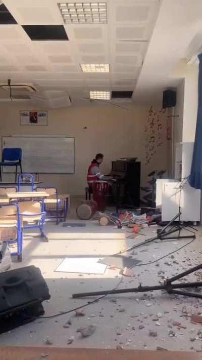 A music teacher is playing a piece by Erik Satie on the piano in the music classroom of a school that has been damaged in the earthquake in Hatay, Turkey.Ars longa, vita brevis