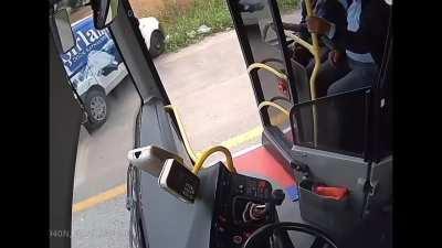 Bus driver jumps into a driverless car through window and stops it.