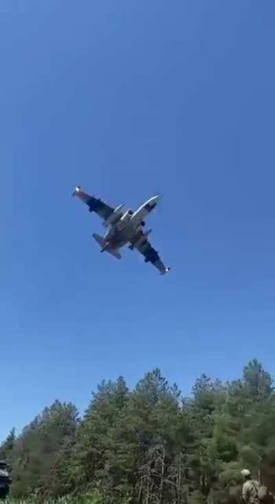 RU POV: Russian SU-25 flying low above a Russian Military column 