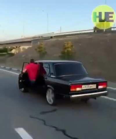 Surfing in a Lada going 85 km per hour.