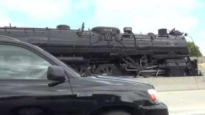 Steam powered locomotive (Santa Fe 3751) smokin it down a California highway