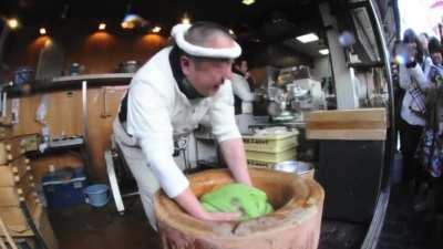 Mochitsuki, the tradition of &quot;mochi-pounding&quot;, where one person hand-mixes the rice dough and one person pounds it using a wooden mallet called a kine.