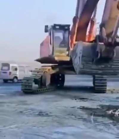 Excavator putting on its own tires