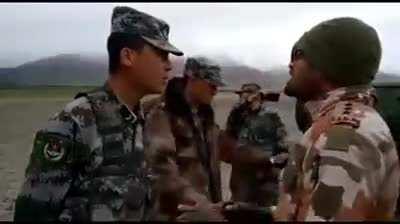 Indian officer speaks to a Chinese officer at the border.