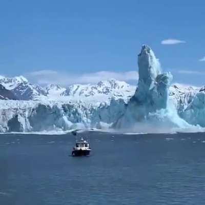 Iceberg breaks off and rises, forming a huge pillar