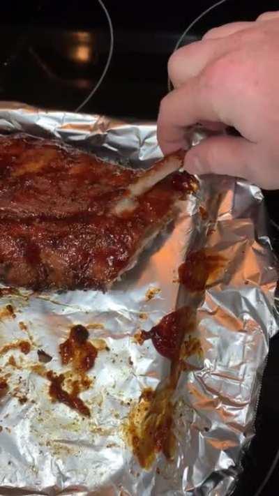 Pulling a bone from these Baby Back Ribs [OC]