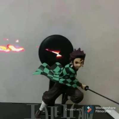 This demon slayer figure has an animation background