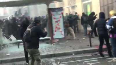 Protesters storming the Bastille, using umbrellas to block police munitions (11.28)