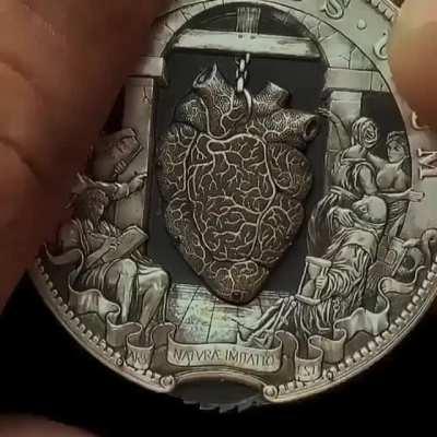 This is an intricate and exquisite coin that has a beating heart inside of it. Made by Russian artist Roman Booteen.