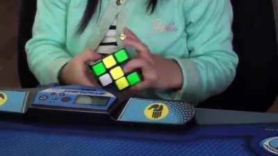 3 years old girl solves a Rubik's cube in 47 seconds.