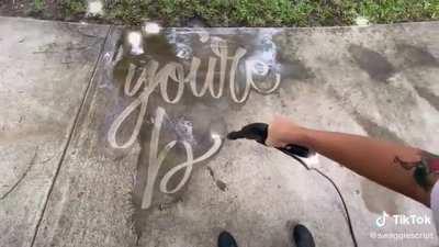 Message from a sidewalk power-washer