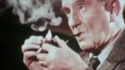 J.R.R. Tolkien smoking his pipe (1950s)