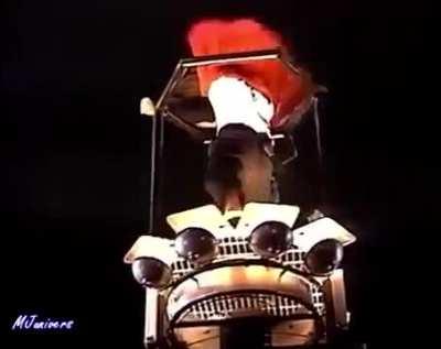 Man jumps on a crane with Michael Jackson during a show