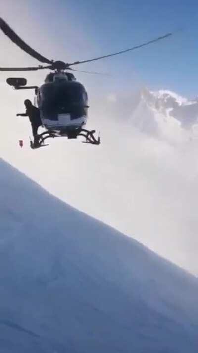 A French police helicopter traveled 7,000 feet up a windy mountainside, getting inches from the snowy slope, in an effort to rescue an injured skier. Unbelievable flying and skill by the pilot.