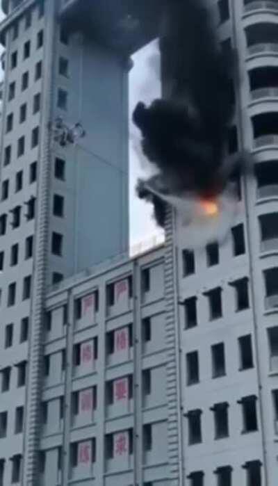 Drone putting out fire in building.