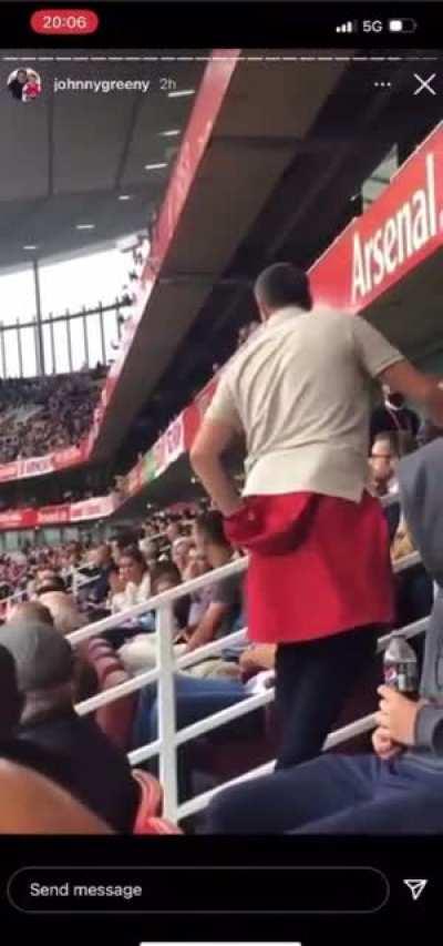 Fan has a go at Edu at the Arsenal Chelsea game. Edu’s wife gives him the middle finger