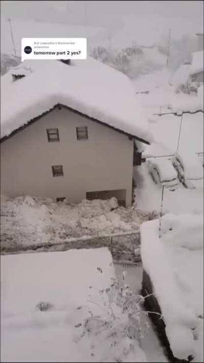 This avalanche slowly moving inbetween the houses