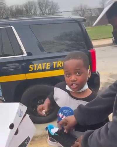 Police officer bought kid a pair of basketball shoes for being his hype man on court.