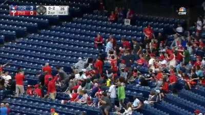 Fan grabs foul ball while holding his child