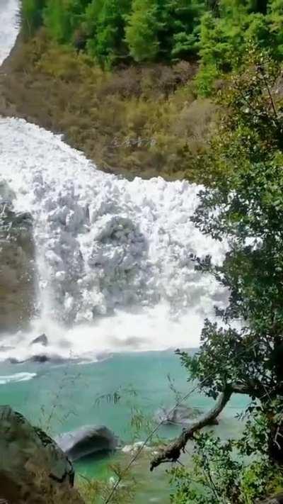 Massive avalanche rolling down a valley.