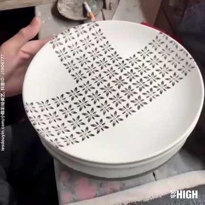 Man decorating a plate by hand