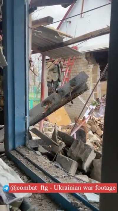 Ukrainian soldier shooting RPG from the ladder.