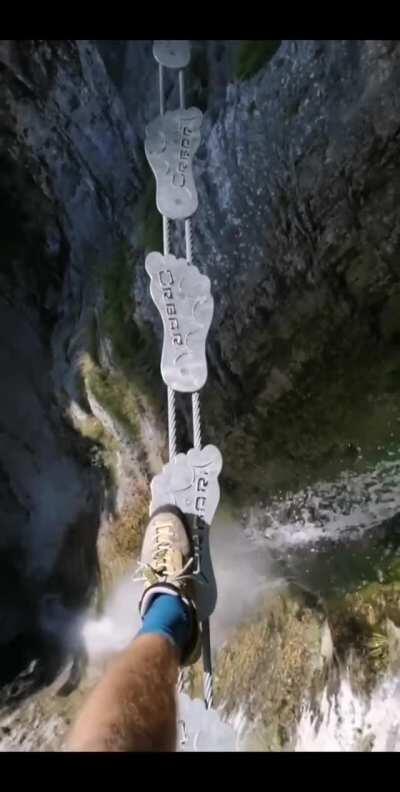 This walking bridge across a chasm in the Ferrata Signora delle Acque, Italy.