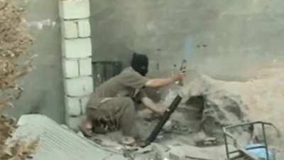 Syrian insurgent discovers govt-boobytrapped mortar round.