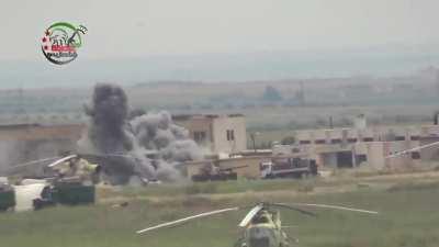 Syrian rebel fighters firing old artillery piece (M30 122mm) towards Menagh airbase, northern Aleppo countryside. Video posted on 18 May 2013.