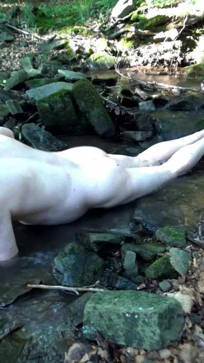 chubby male thrusts naked in a spring