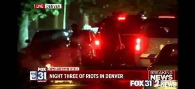 Denver cop seen pushing a reporter into a fire