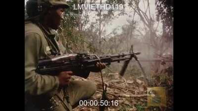 [Vietnam] “Black Rambo” hip fires his M-60 to suppress a tree line, Operation Cedar Falls.