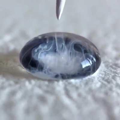 Adding black and white dye to a water droplet